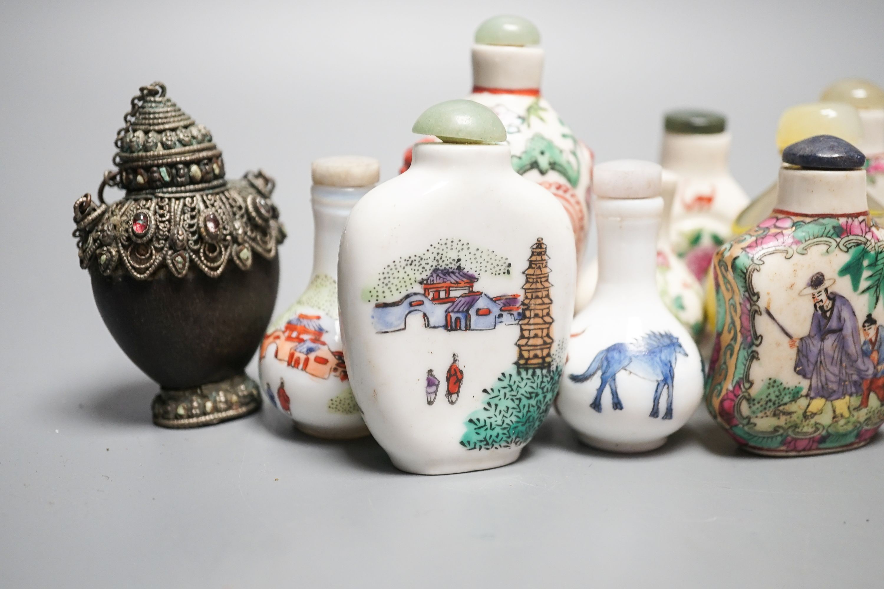 A collection of Chinese snuff bottles, 20th century, including a carved cinnabar lacquer and hardstone inlaid snuff bottle, 7.4cm (23)